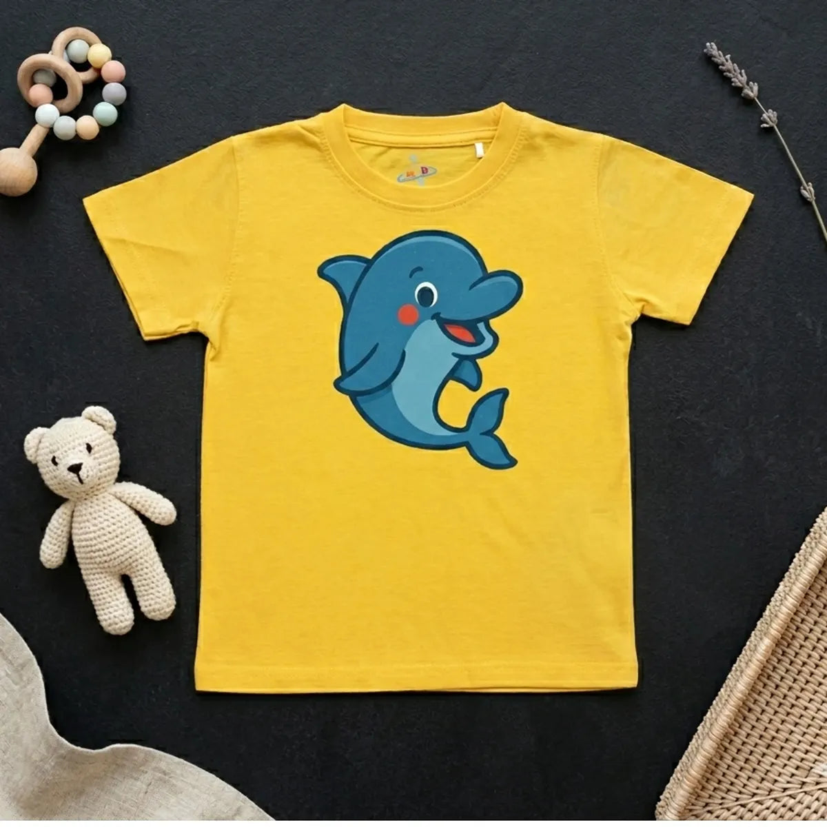 Yellow dolphin print kids t-shirt with ocean theme flatlay